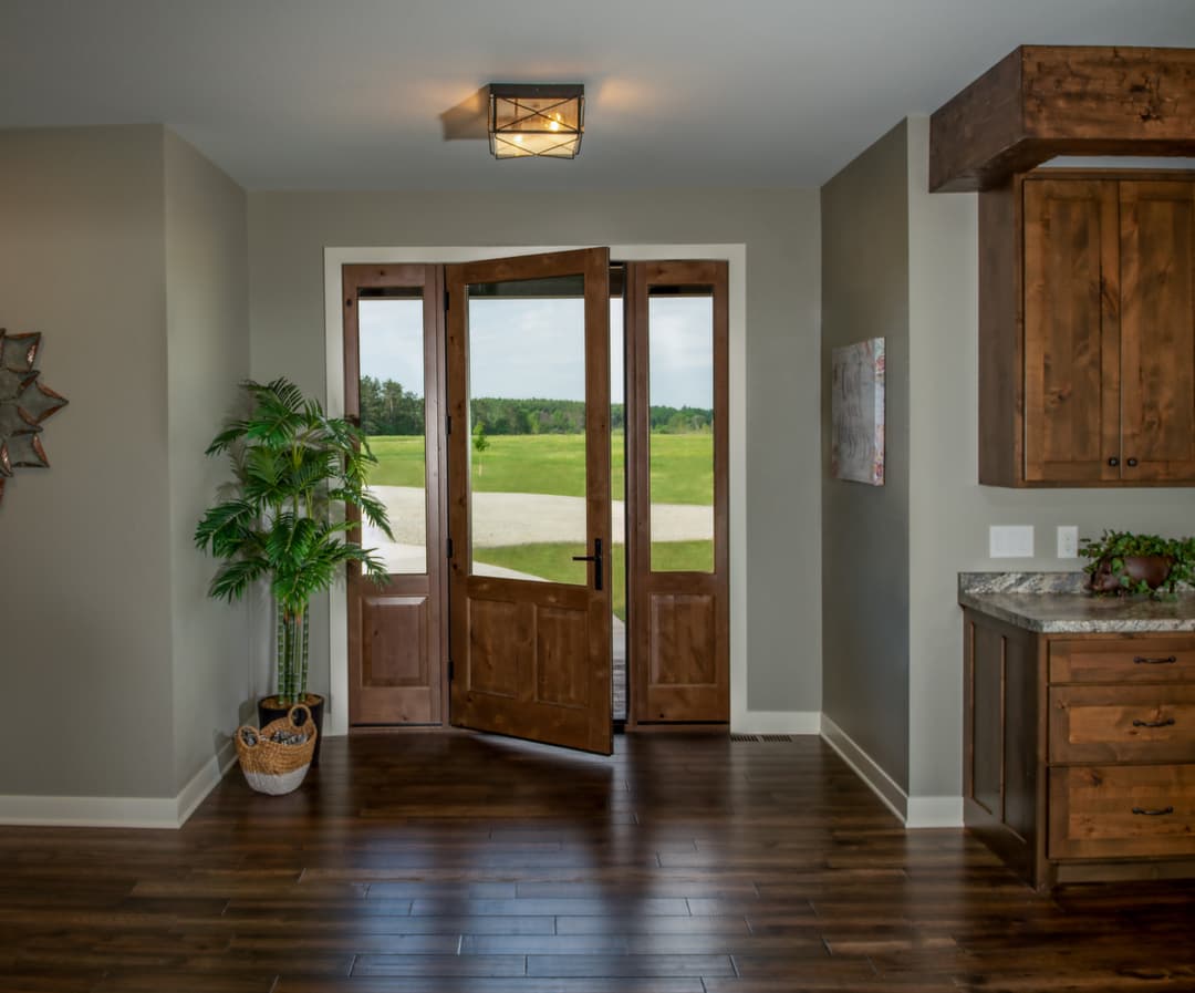 Ultra Series inswing door with raised panels and sidelites