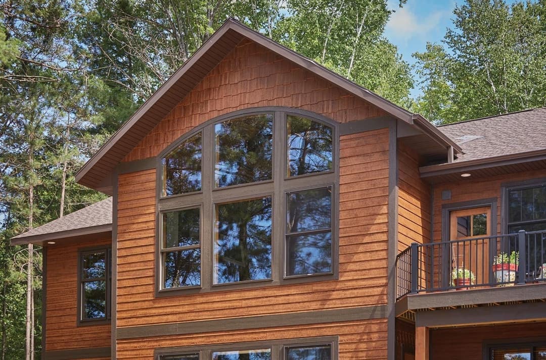 Forgent Series double hungs, stationary units, and cottage-style double hungs, Direct set transoms in custom shapes to form a segment head, Glastra exterior in Bronze